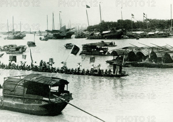 Dragon Boat- The caption for this 1900 photo reads: This boat is very long and very narrow It is propelled by 40 or more men with paddles and is capable of great speed. A dragon boat is a human-powered watercraft originating from the Pearl River Delta region of China's southern Guangdong Province. These were made of teak, but in other parts of China, different kinds of wood are used.