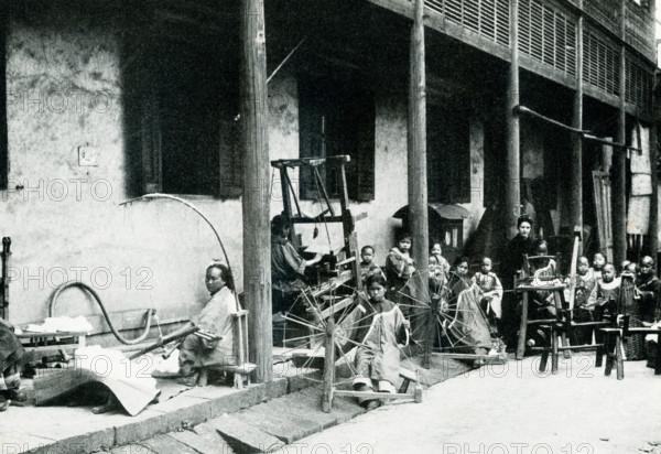 Christian Mission Industrial School.  This photo dates to 1900.  It shows a young woman missionary teaching children to spin and weave. The missionaries at ther school also taught the industries and laws of health and the Christian religion.