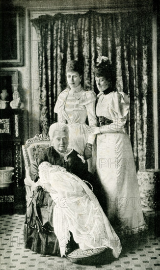 This images shows Her majesty Queen Victoria with the Baby Prince and the Princess Alexandra of Wales (wife of Queen Victoria’s son  Edward who became Edward VII) and Duchess of York (wife of Duke of York who became King George V and Queen Mary).