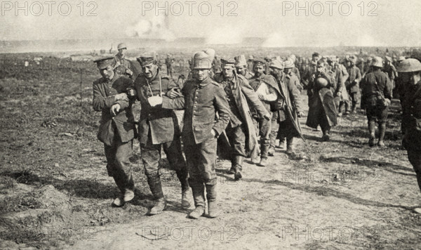 This photo shows Private Peat who fought in World War I. The caption reads: “Prisoners going to rear.”  It appeared in Harold R Peat's book 'Private Peat' published in 1917.