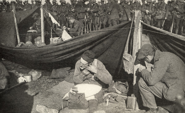 This photo shows Private Peat who fought in World War I. The caption reads: “Close shave in Flanders.”  It appeared in Harold R Peat's book 'Private Peat' published in 1917.