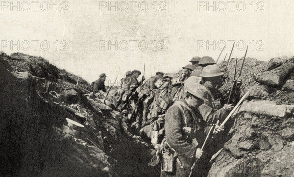 This photo shows Canadian troops who fought in World War I. The caption reads: Ready to go over—trenches Canadians WWI.  It appeared in Harold R Peat's book 'Private Peat' published in 1917.