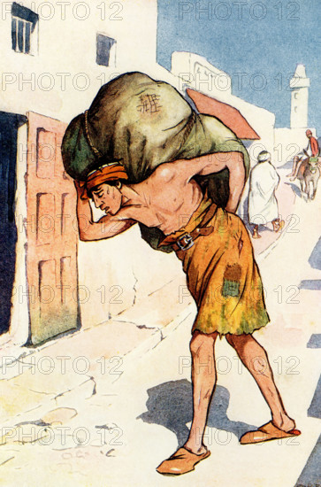 The tale of Sindbad the Sailor tells of an Arab adventurer at sea during the ninth and tenth centuries A.D. The 1917 caption reads: 'Hindbad—from Sindbad the sailor—was carrying a very heavy load.' Åccording to the tale, Hindbad, weighed down by a heavy load, passes by Sindbad the Sailor's grand house. He mutters some envious words, which Sindbad hears and invites him in, then tells Hindbad of his seven perilous voyages. Hindbad regrets his envious words, but Sindbad welcomes him=, gives him money, and invites him to come often, counting Hindbad now among his close friends. The tale of Sindbad the Sailor tells of an Arab adventurer at sea during the ninth and tenth centuries A.D.