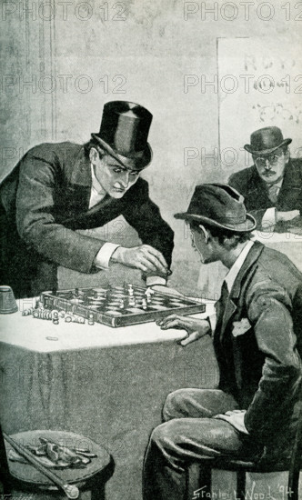 This 1895 illustration shows a scene from A Bid for Fortune by Guy Boothby, with caption: He half stood, half crouched over the board. Boothby was once well known for his series of novels about Doctor Nikola, an occultist anti-hero seeking immortality and world domination. The adventures of Nikola were launched with A Bid for Fortune. Guy Newell Boothby (1867 – 1905) was a prolific Australian novelist and writer, noted for sensational fiction in variety magazines around the end of the 19th century. He lived mainly in England.