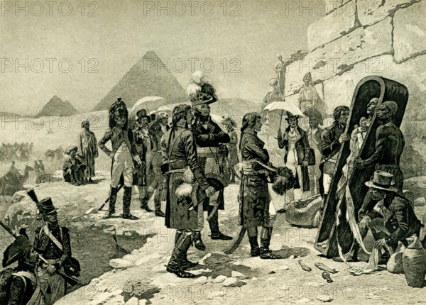 The caption accompanying this 1903 illustration in Gaston Maspero’s book on  History of Egypt reads: “Bonaparte in Egypt after painting by M Orange.”  When Napoleon was n Egypt, he toured the ancient sites, including the Sphinx, and had his savants note all pertinent facts. Here he and his men are shown looking at an uncovered mummy. Maurice Orange, who was born in 1867 and died in 1916, was a French painter and artist.