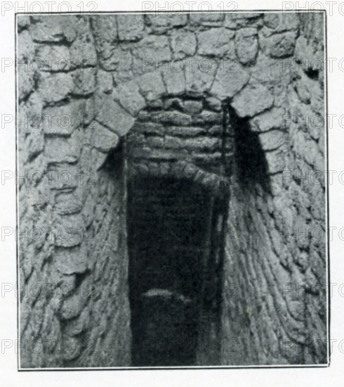 Shown in this early 1900s photo by British archaeologist John Garstang is a domed entrance to a brick tomb of the Old Kingdom. This Third Dynasty mudbrick tomb, along with others, was uncovered at Reqaqna, in Middle Egypt.