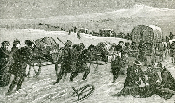 This illustration from 1896 shows a Mormon Hand-Cart Comoany crossing the Plains. The Mormon handcart pioneers were participants in the migration of members of The Church of Jesus Christ of Latter-day Saints to Salt Lake City, Utah, between 1856 and 1860. They used two-wheeled handcarts to transport their belongings. Two of the companies, the Willie and Martin companies, started their journey dangerously late in 1856 and were caught by heavy snow and severe temperatures in central Wyoming. Despite a dramatic rescue effort, more than 210 of the 980 pioneers in these two companies died along the way.