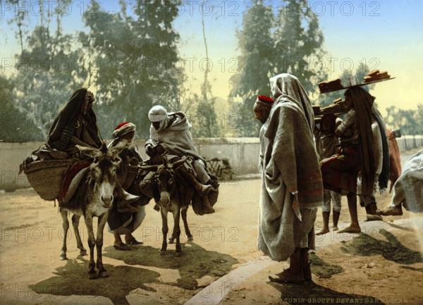 Bedouins with donkeys, group in front of Bab Aleona, Tunisia, around 1895, historical, digitally restored reproduction from an original from the 19th century.