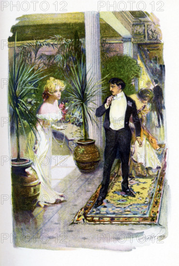 Amos Judd is a novel written in 1895 by J.A. Mitchell (1845-1918). It takes place against a background of civil war in northern India. The seven-year-old rajah is smuggled out by three faithful followers - two Hindus and one American. The boy was brought to a Connecticut farmhouse and given the name Amos Judd. As he grew up, he had the amazing ability to foresee events. The caption accompanying this illustration in the novel: I beg your pardon. I was startled. Miss Cabot had gone to find some cooler air and was by a conservatory when she was startled by the presence of someone - it turned out to be Mr. Judd and his companion, a pretty girl in pink.