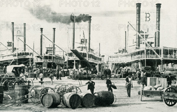 The photo dates from 1922. The caption reads: The Busy River Front at Louisville. Louisville, with a population of a quarter of a million, is the largest city of Kentucky and the center of a vast distributing and export trade, with exceptional facilities by river and railroad.