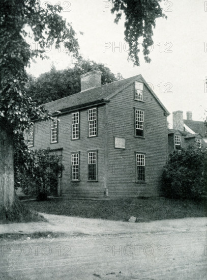 The 1920 caption reads: ""Lexington, Massachusetts, the house in which Samuel Adams and John Hancock were asleep when roused by Paul Revere."" The Hancock-Clark House in Lexington, Massachusetts, is where John Hancock and Samuel Adams were awakened by Paul Revere on April 18, 1775. The men were asleep in ""the parlor"" of the house built in 1737 by Thomas Hancock for his father Rev. John Hancock.