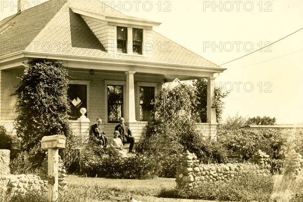 Farmhouse on Plainville Road in New Bedford. This photo dates to around 1915 and shows a house on a farm in the northend of New Bedford; Massachusetts. The owner is the man at right; and two. of his children are with him. The area was called Plainville; and the location of the house was Plainville Road.