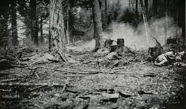 The caption for this photo that accompanied a book published in 1922 reads: How the 'pick'em off"" in a skirmish line advance. they utilize every tree trunk and every stump, and advance in short jumps.