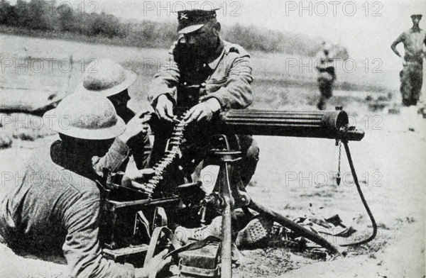 In this photo, dating to before 1922, relates to World War I. The caption reads: Yankees receiving instruction by an English sergeant in the use of a machine gun.