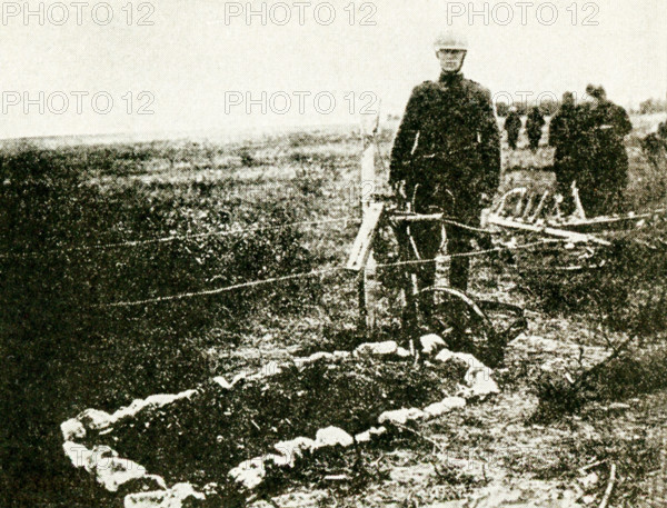 This photo, dating to before 1922, relates to World War I. The caption reads: The grave of Lieut. Quentin Roosevelt, aviator and son of ex-President Roosevelt, who was killed during an air raid over enemy lines on July 14, 1918, has been located in France.