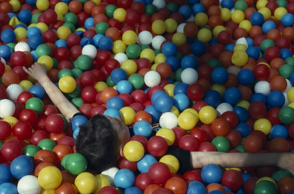 10003265 CHILDREN  Play Child playing in multi coloured fun balls