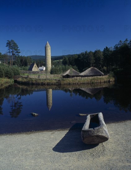 NORTHERN IRELAND, County Tyrone, Ulster History Park, View over Crannog and Round Tower reflected in the water