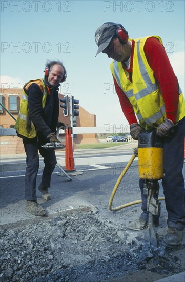 ARCHITECTURE, Construction, Roadworks, Workmen with pneumatic drill digging up the road