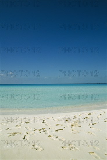 CUBA, Isla De Juventud, Cayo Largo, Playa Serena looking out to sea with footprints in the sand