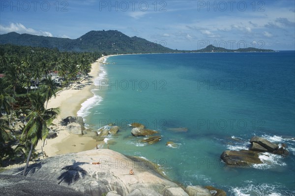 THAILAND, Surat Thani, Koh Samui, Lamai beach and coastline seen from hillside with coconut palm trees coming down to the shoreline