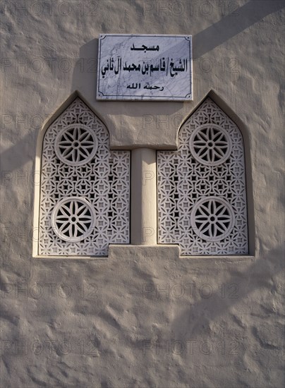 QATAR, Doha, Window detail of Small Mosque in the old souk area with sign in Arabic above it.