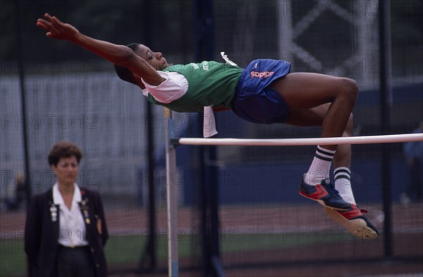 10028033 SPORT  Athletics High Jump Competitor in schools high jump event arching backwards over bar.