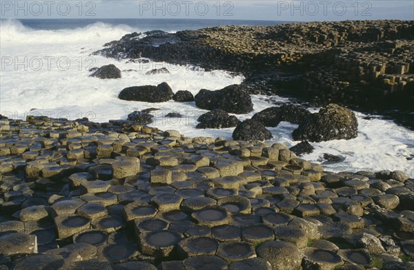 NORTHERN IRELAND, County Antrim, Moyle, Giants Causeway. View over the naturally formed polygonal basalt columns and wash of sea