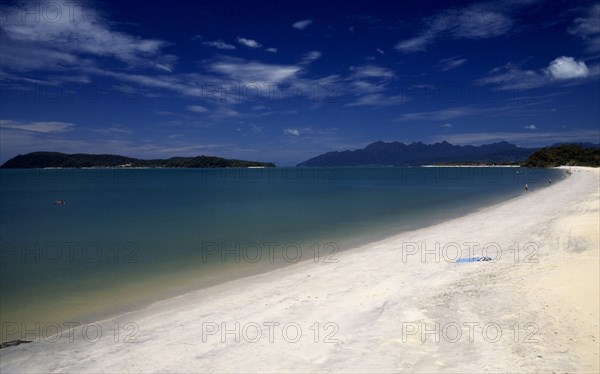 MALAYSIA, Kedah, Langkawi, Pantai Tengah beach looking towards Pulau Rebak Besar island and Gunung Mat Cincang