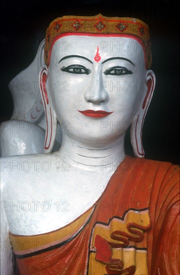 MYANMAR, Yangon, "Shwedagon Pagoda.  White faced Buddha figure, detail of head and shoulders."