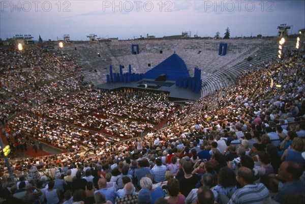 ITALY, Veneto , Verona, "The Arena, Roman amphitheatre.  View over seated crowds towards central stage. "