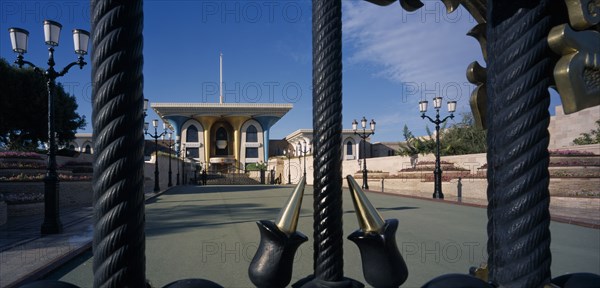 OMAN, Muscat, "The Sultans Palace, seen through wrought metal bars of gateway."