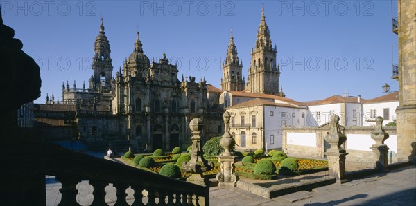 SPAIN, Castilla Y Leon, Leon, "Cathedral, gothic exterior and spires partly seen above roof tops, stone balustrade in shadow in the foreground."