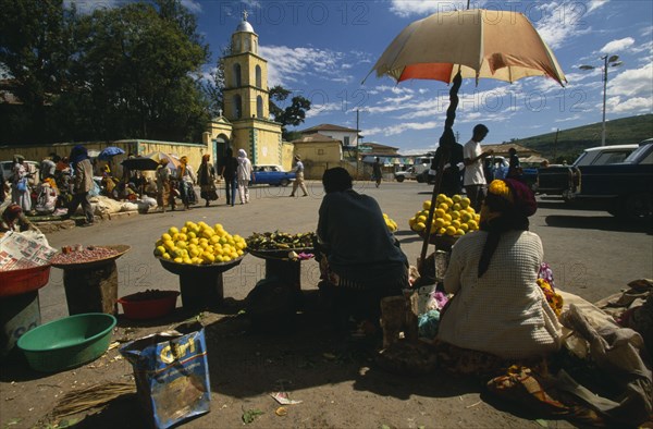 ETHIOPIA, Harerge Province, Harer, The Square.  Market with women selling fruit from stall in the foreground.