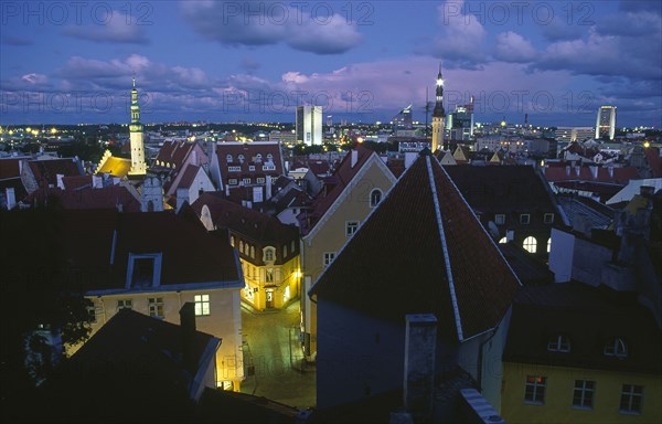 ESTONIA, Tallinn, View across Old Town rooftops at night.