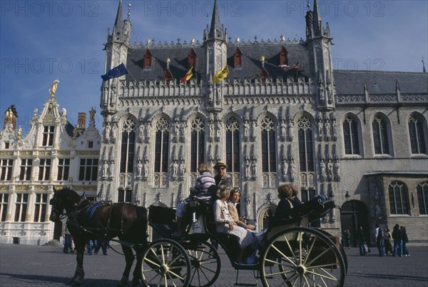 BELGIUM, West Flanders, Bruges, Tourist horse and carriage outside the Stadhuis in Burg Square