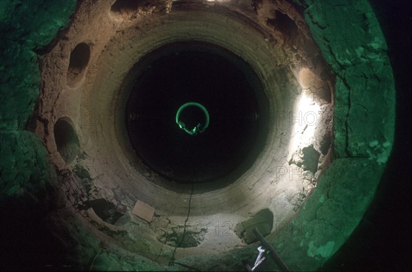 CUBA, Havana Province, Mariel, Inside a tunnel under construction with workers in the distance in a pool of light