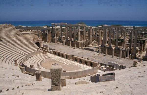 LIBYA, Tripolitania, Leptis Magna, View over Roman amphitheatre towards the Mediterranean Sea behind.