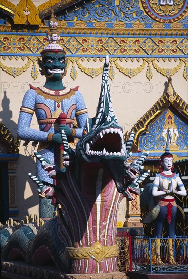 MALAYSIA, Penang, Georgetown, Wat Chayamangkalaram.  Temple guardsman and dragon statues.