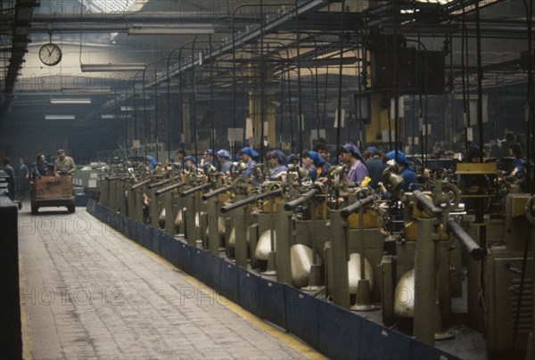 ROMANIA, Bucharest, Factory interior with workers at machines