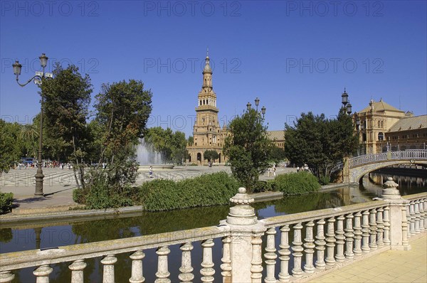 SPAIN, Andalucia, Seville, Plaza de Espana. View over water pool that surrounds the semicircular plaza
