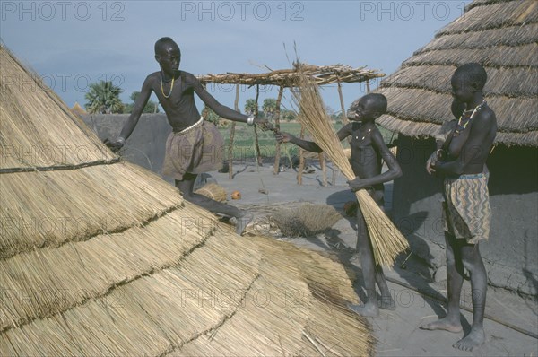 SUDAN, People, Dinka tribe thatching hut in cattle camp.