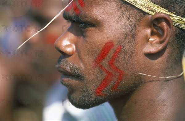 PACIFIC ISLANDS, Melanesia, Vanuatu Islands, Efate Island.  Port Vila.  Man from the island of Erromango at a Melanesian cultural festival.  Portrait in profile to left with red painted facial decoration.