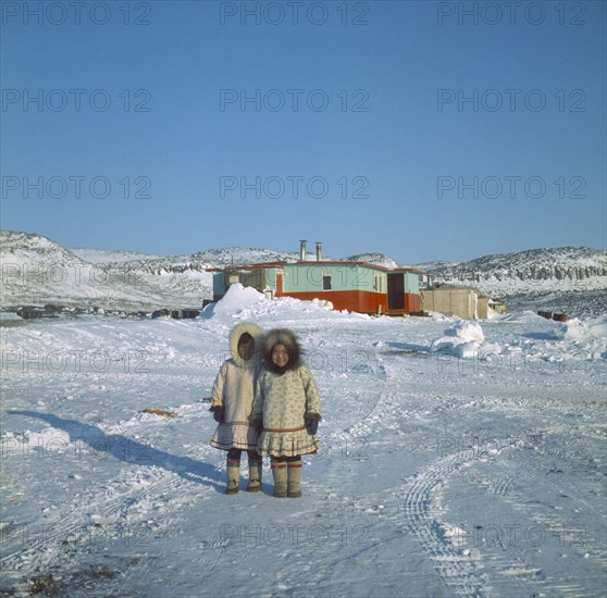 CANADA, Nunavut, Baffin Island, Young Innuit girls outside settlement.