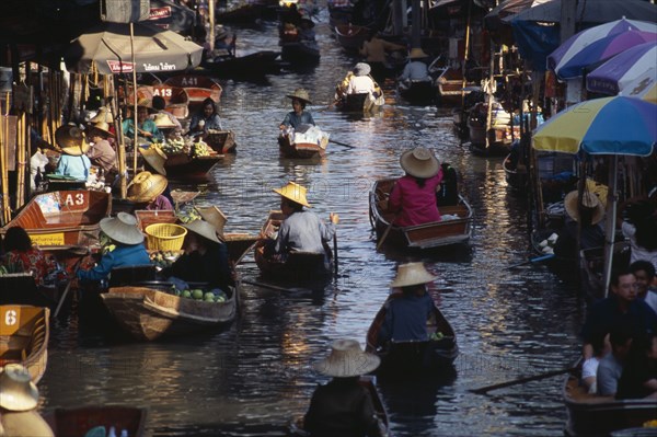 THAILAND, South, Bangkok, Damnoen Saduak Floating Market fruit vendors in their canoes on the main canal