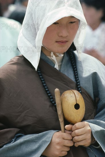 SOUTH KOREA, Seoul, Portrait of young woman at Buddhist dance.