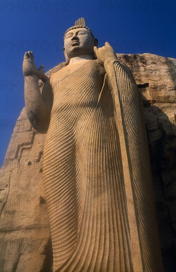 SRI LANKA, Aukana, Twelve metre high standing Buddha believed to have been sculpted during the reign of Dhatusena in the 5th century AD.