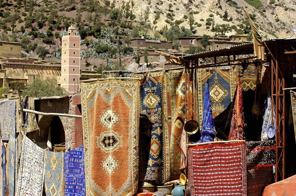 MOROCCO, Marrakech, Carpet shop with rugs for sale hanging outside a shop