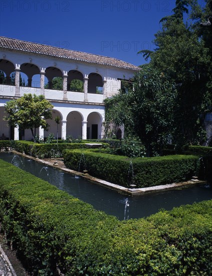 SPAIN, Andalucia, Granada, The Alhambra. Generalife Gardens. Jardin de Sultana with fountains and Generalife Palace or Summer Palace