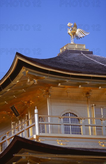 JAPAN, Honshu, Kyoto, Kinkaku Ji Temple aka the Golden Pavilion. Section of the gold leaf covered structure and rooftop bronze phoenix