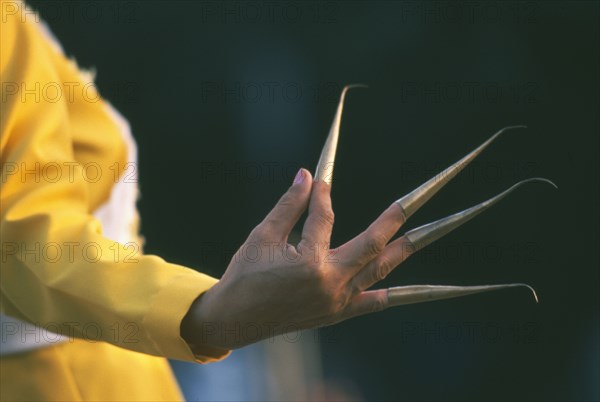 THAILAND, Chiang Mai, San Si District, Traditional Thai fingernail dancer performing.  Cropped view with focus on hand gesture.